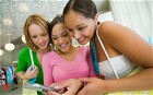 Three Girls Looking at Cell Phone picture: Rise in nomophobia: fear of being without a phone
